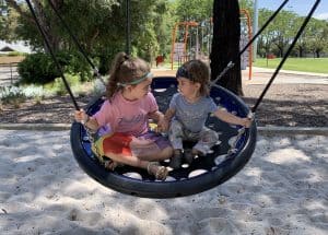 Children playing on a big swing